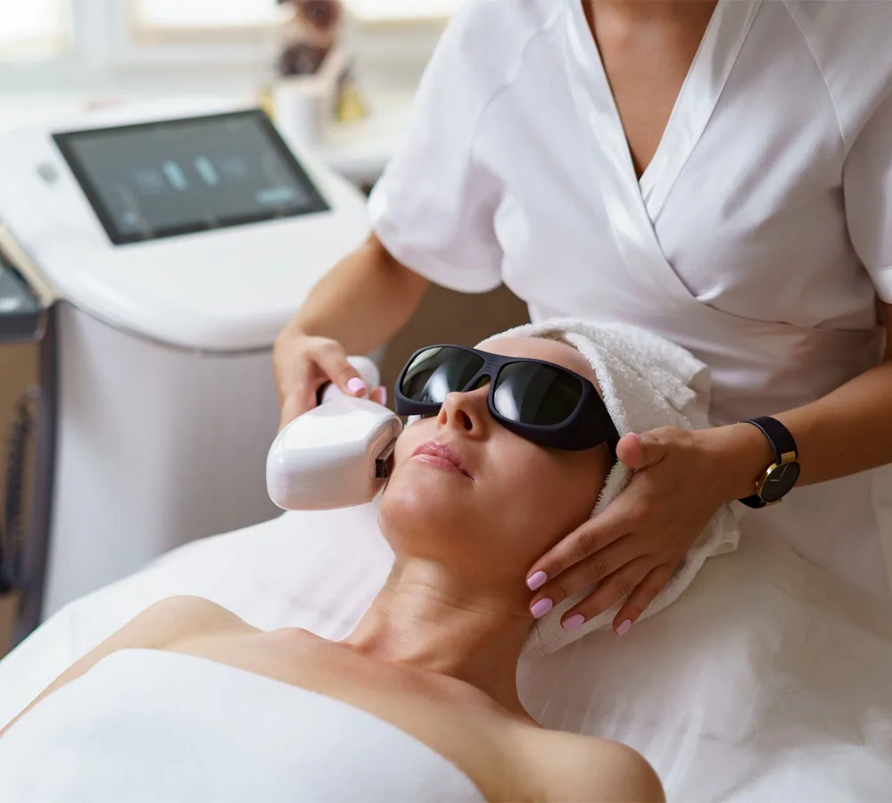 Woman with protective goggles during laser skin rejuvenation